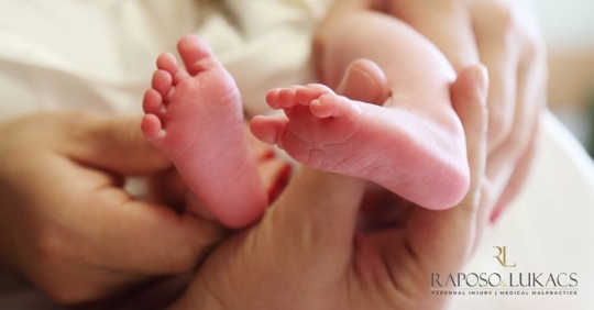 holding baby's feet